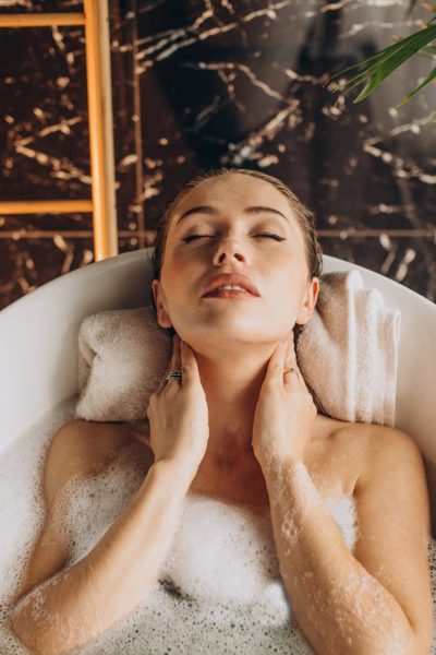 Woman relaxing in bath with bubbles
