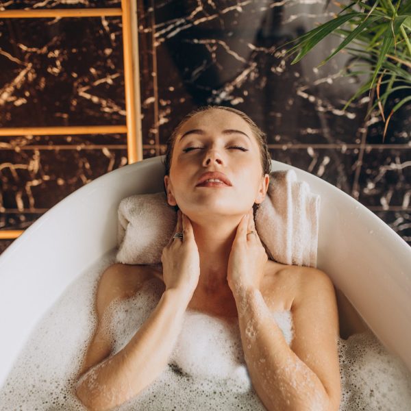 Woman relaxing in bath with bubbles